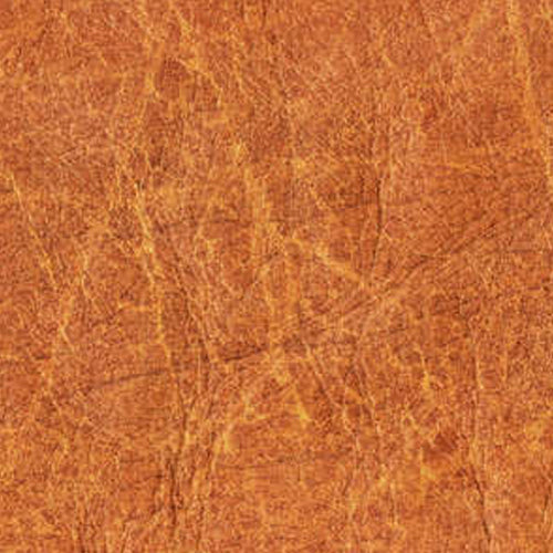 Tom's Dark Leather Waxmelt – geurblokje van sojawas met stoere kruidige tonen van kardemom, jasmijn en patchouli. Foto van een lederstructuur in bruin.