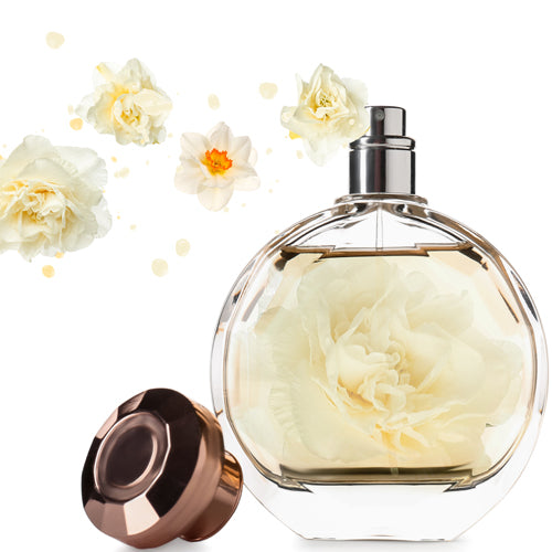 Belle La Vie Waxmelt – geurblokje van sojawas met iris, oranjebloesem en jasmijn. Afbeelding van een luxe parfumfles met bloemaccenten.