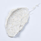 Detail van Phytomer lichaamsscrub met licht zand, zwart vulkanisch zand en puimsteen voor een zachte huid